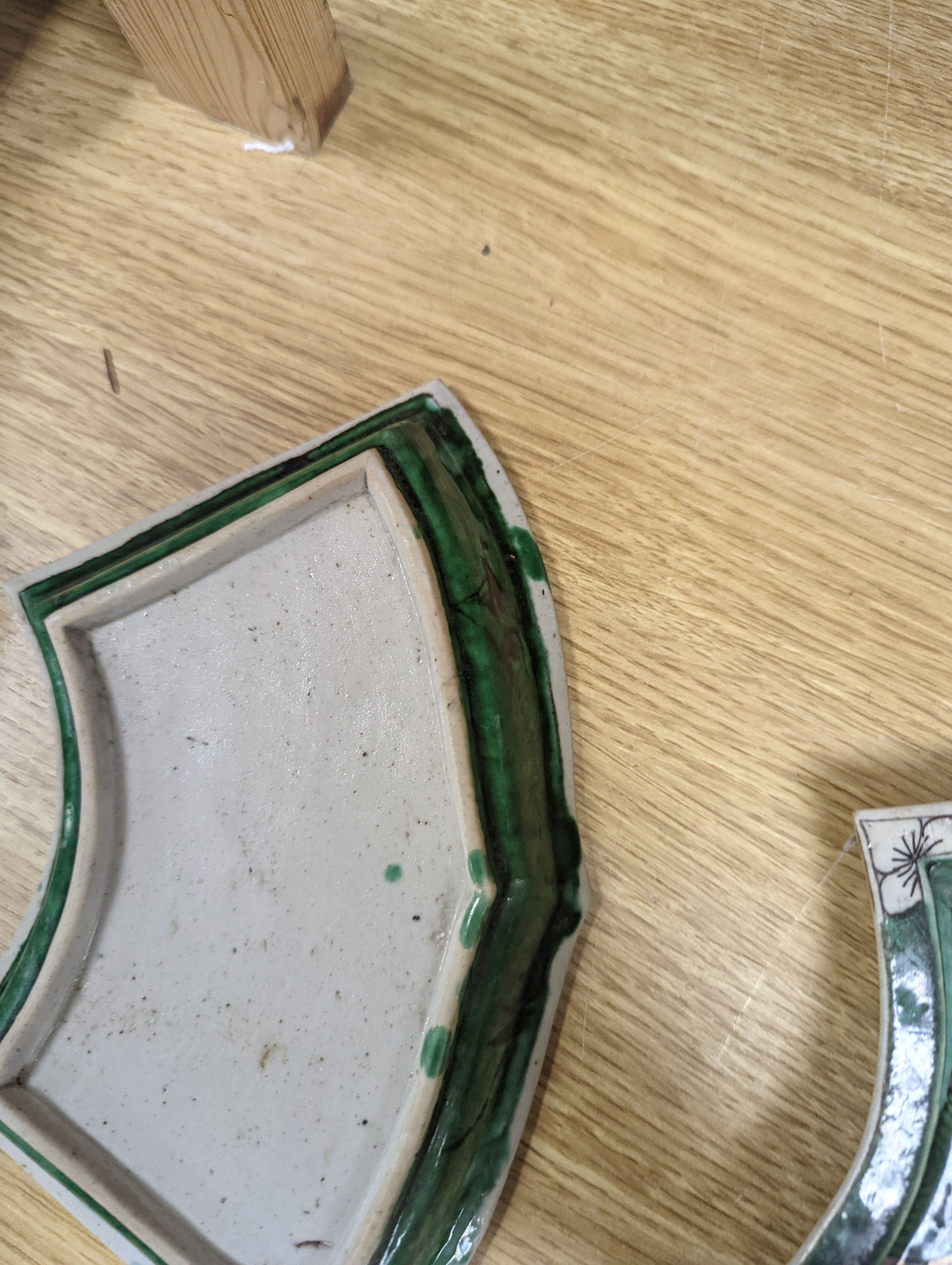 A pair of Chinese famille verte biscuit fan-shaped sweetmeat dishes, Kangxi, 20 cms wide.